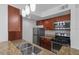 Tasteful kitchen with granite countertops, stainless steel appliances and wood cabinets at 5156 Conroy Rd # 1124, Orlando, FL 32811