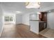 Bright living room featuring wood-look floors, white walls, and a large window letting in natural light at 5156 Conroy Rd # 1124, Orlando, FL 32811