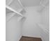 Spacious walk-in closet offering ample storage with shelves and wood look flooring at 5156 Conroy Rd # 1124, Orlando, FL 32811