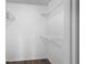 Walk-in closet featuring wire shelving and wood look flooring at 5156 Conroy Rd # 1124, Orlando, FL 32811