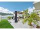 Backyard patio features a pergola, outdoor seating, a lake view, and landscaping for relaxing at 5248 Royal Point Ave, Kissimmee, FL 34746