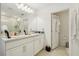 Bright bathroom with double sinks, modern lighting, and a separate toilet room for convenience at 5248 Royal Point Ave, Kissimmee, FL 34746