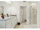 Bright bathroom with double sinks, a glass-enclosed shower, and a separate toilet room at 5248 Royal Point Ave, Kissimmee, FL 34746