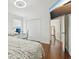 Bedroom with hardwood floors featuring a desk and a closet with white doors at 5248 Royal Point Ave, Kissimmee, FL 34746