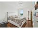 Bright bedroom with hardwood floors and a queen sized bed with stylish décor at 5248 Royal Point Ave, Kissimmee, FL 34746