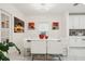 Modern dining room with a large white table, seating for eight, and contemporary art at 5248 Royal Point Ave, Kissimmee, FL 34746