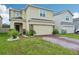 Charming two-story home with brick paver driveway and well manicured front yard at 5248 Royal Point Ave, Kissimmee, FL 34746