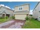 Charming two-story home with brick paver driveway and well manicured landscaping at 5248 Royal Point Ave, Kissimmee, FL 34746