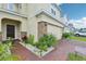 Charming home featuring well-manicured landscaping, stone accents, and a paver driveway at 5248 Royal Point Ave, Kissimmee, FL 34746