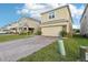 Charming two-story home with a brick driveway and a two-car garage at 5248 Royal Point Ave, Kissimmee, FL 34746