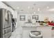 Bright kitchen featuring marble floors, stainless steel appliances, and a spacious granite island at 5248 Royal Point Ave, Kissimmee, FL 34746