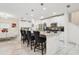 Modern kitchen with a large island, bar seating, and white cabinetry at 5248 Royal Point Ave, Kissimmee, FL 34746