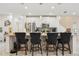 Close-up of the kitchen island featuring bar stools, white cabinetry, and stylish countertops at 5248 Royal Point Ave, Kissimmee, FL 34746