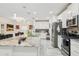 Contemporary kitchen featuring stainless steel appliances, a central island, and sleek, white cabinetry at 5248 Royal Point Ave, Kissimmee, FL 34746