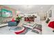 Spacious living room featuring modern decor, a large TV, and an open floor plan connected to the kitchen at 5248 Royal Point Ave, Kissimmee, FL 34746