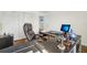 Spacious office featuring a dark modern desk and a comfortable leather chair at 5248 Royal Point Ave, Kissimmee, FL 34746