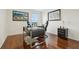 Office with hardwood floors, modern black desk, comfortable executive chair, and view from the large picture window at 5248 Royal Point Ave, Kissimmee, FL 34746