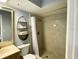 Bathroom featuring walk-in shower with tile surround, updated vanity, and decorative shelving at 567 E Orange St # 567, Altamonte Springs, FL 32701