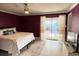 Bedroom with neutral rug, ceiling fan, and sliding glass doors leading to outdoor greenery at 567 E Orange St # 567, Altamonte Springs, FL 32701