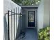 Enclosed front porch with black metal gate and inviting door with glass detail providing character and charm at 567 E Orange St # 567, Altamonte Springs, FL 32701