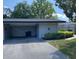 Charming home exterior with a covered parking, green shrubs and a well-manicured lawn at 567 E Orange St # 567, Altamonte Springs, FL 32701