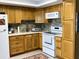 Well-lit kitchen featuring wood cabinets, stainless faucet, and modern appliances creating a welcoming space at 567 E Orange St # 567, Altamonte Springs, FL 32701