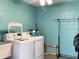 Bright laundry room featuring a washer, dryer, and plenty of space for cleaning and storage at 567 E Orange St # 567, Altamonte Springs, FL 32701