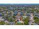 Aerial view of the community showing multiple buildings, lake, tennis courts and pools at 6142 Westgate Dr # 204, Orlando, FL 32835
