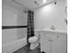 Bathroom featuring a modern vanity and tiled shower-tub combo and black and white tiling at 6142 Westgate Dr # 204, Orlando, FL 32835