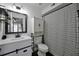 Bathroom with a modern vanity, decorative mirror, and striped shower curtain at 6142 Westgate Dr # 204, Orlando, FL 32835