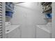 Functional laundry room features shelving, washer, and dryer hookups for easy chore completion at 6142 Westgate Dr # 204, Orlando, FL 32835