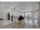 A cozy kitchen flows into a well-lit living room area featuring modern lighting and sleek floors at 6142 Westgate Dr # 204, Orlando, FL 32835