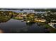 A stunning aerial view of luxurious waterfront homes on a lake with private boat docks and lush greenery at 645 Manor Rd, Maitland, FL 32751