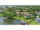 Luxury lakefront estate with boat dock, pool, and lush landscaping creates an idyllic waterfront setting at 645 Manor Rd, Maitland, FL 32751