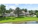 Expansive estate features well-manicured lawn, private pool, and picturesque lakefront setting at 645 Manor Rd, Maitland, FL 32751