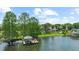 Aerial view of a home by the lake showcasing a private dock, lush greenery, and serene waterfront living at 645 Manor Rd, Maitland, FL 32751