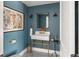 Stylish powder room with unique sink, modern fixtures and blue accent wall at 645 Manor Rd, Maitland, FL 32751