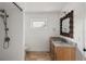 Bathroom with shower, marble vanity with sink, and neutral-toned tile flooring and walls at 645 Manor Rd, Maitland, FL 32751