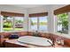 Bathtub with tile surround and a view of lake from a bank of windows at 645 Manor Rd, Maitland, FL 32751