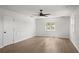 Spacious bedroom features hardwood floors, a ceiling fan, and natural light from several windows at 645 Manor Rd, Maitland, FL 32751