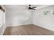 Bright bedroom features hardwood floors, a ceiling fan, and natural light from several windows at 645 Manor Rd, Maitland, FL 32751