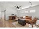 Bonus room with a comfortable brown sofa, trunk coffee table and three large windows at 645 Manor Rd, Maitland, FL 32751