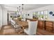 Dining room features an elegant table set for a meal with large windows and an expansive view of the back yard at 645 Manor Rd, Maitland, FL 32751