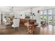 Open-concept dining room with a long wooden table and chairs, seamlessly connects to the living area and kitchen at 645 Manor Rd, Maitland, FL 32751