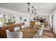 The dining area features a rustic wood table and a view of the fireplace and kitchen at 645 Manor Rd, Maitland, FL 32751