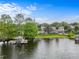 Stunning waterfront property with a large home, boat dock, and lush greenery at 645 Manor Rd, Maitland, FL 32751