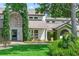 Beautiful home with brick pathway, lush landscaping, and an arched doorway at 645 Manor Rd, Maitland, FL 32751