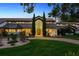 Stately home with a manicured lawn, arched entry, and lush landscaping exudes curb appeal at 645 Manor Rd, Maitland, FL 32751