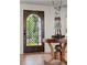 Elegant foyer featuring a decorative front door, hardwood floors, and unique decor at 645 Manor Rd, Maitland, FL 32751