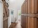 Hallway with wood floors, sliding barn door, and large cabinet with many drawers at 645 Manor Rd, Maitland, FL 32751